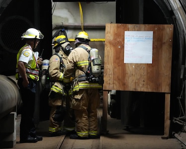 Federal Fire Department personnel discuss response plans during a spill response exercise at the Red Hill Bulk Fuel Storage Facility on Joint Base Pearl Harbor-Hickam, Hawaii, July 13, 2023. This exercise is mandated by the Hawaii Department of Health emergency state order and the U.S. Environmental Protection Agency 2023 Consent Order. Joint Task Force-Red Hill’s (JTF-RH) Response Directorate’s purpose is to protect the aquifer and environment by analyzing spill scenarios and developing appropriate mitigation measures. JTF-RH is committed to working with all relevant government agencies to ensure Red Hill is defueled safely, expeditiously, and in compliance with all federal, state and local laws, policies and regulations. (DoD photo by Cpl. Gabrielle Zagorski)