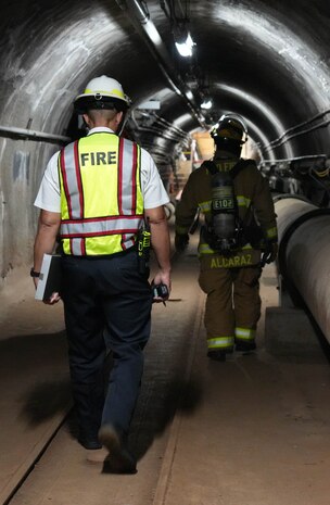 Federal Fire Department personnel walk through the tunnel in the Red Hill Bulk Fuel Storage Facility during a spill response exercise on Joint Base Pearl Harbor-Hickam, Hawaii, July 13, 2023. This exercise is mandated by the DOH emergency state order and the EPA 2023 Consent Order. JTF-RH Response Directorate’s purpose is to protect the aquifer and environment by analyzing every scenarios and developing appropriate mitigation measures. JTF-RH is committed to working with all relevant government agencies to ensure Red Hill is defueled safely, expeditiously, and in compliance with all federal, state and local laws, policies and regulations. (DoD photo by Cpl. Gabrielle Zagorski)
