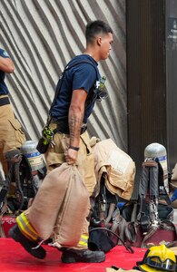A Federal Fire Department firefighter moves sandbags during a spill response exercise on Joint Base Pearl Harbor-Hickam, Hawaii, July 13, 2023. This exercise is mandated by the Hawaii Department of Health emergency state order and the U.S. Environmental Protection Agency 2023 Consent Order. Joint Task Force-Red Hill’s (JTF-RH) Response Directorate’s purpose is to protect the aquifer and environment by analyzing spill scenarios and developing appropriate mitigation measures. JTF-RH is committed to working with all relevant government agencies to ensure Red Hill is defueled safely, expeditiously, and in compliance with all federal, state and local laws, policies and regulations. (DoD photo by Cpl. Gabrielle Zagorski)