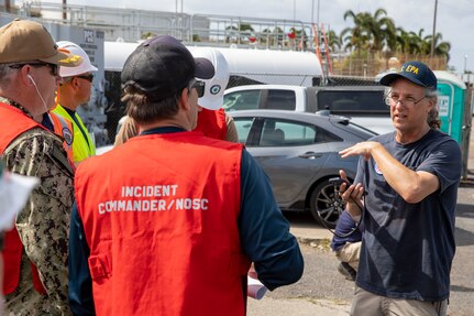 Ben Castellana, an on-scene coordinator with the U.S. Environmental Protection Agency, speaks with Joint Task Force-Red Hill (JTF-RH) personnel during a spill response exercise on Joint Base Pearl Harbor-Hickam, Hawaii, July 13, 2023. This exercise is mandated by the Hawaii Department of Health emergency state order and the U.S. Environmental Protection Agency 2023 Consent Order. JTF-RH Response Directorate’s purpose is to protect the aquifer and environment by analyzing every possible spill scenario and developing appropriate mitigation measures. JTF-RH is committed to working with all relevant government agencies to ensure Red Hill is defueled safely, expeditiously, and in compliance with all federal, state and local laws, policies and regulations. (DoD photo by U.S. Army Spc. Matthew Mackintosh)