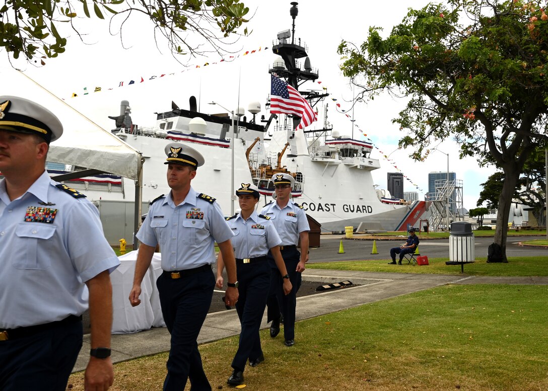 U.S. Coast Guard Cutter Kimball’s (WMSL 756) crewmembers file in during the Coast Guard Cutter Kimball’s change of command ceremony on Base Honolulu, July 21, 2023. Rear Adm. Brendan C. McPherson, deputy commander of U.S. Coast Guard Pacific Area, presided over the ceremony in which Capt. Bob Kinsey relieved Capt. Tom D’Arcy as Kimball’s commanding officer. U.S. Coast Guard photo by Chief Petty Officer Matthew Masaschi.