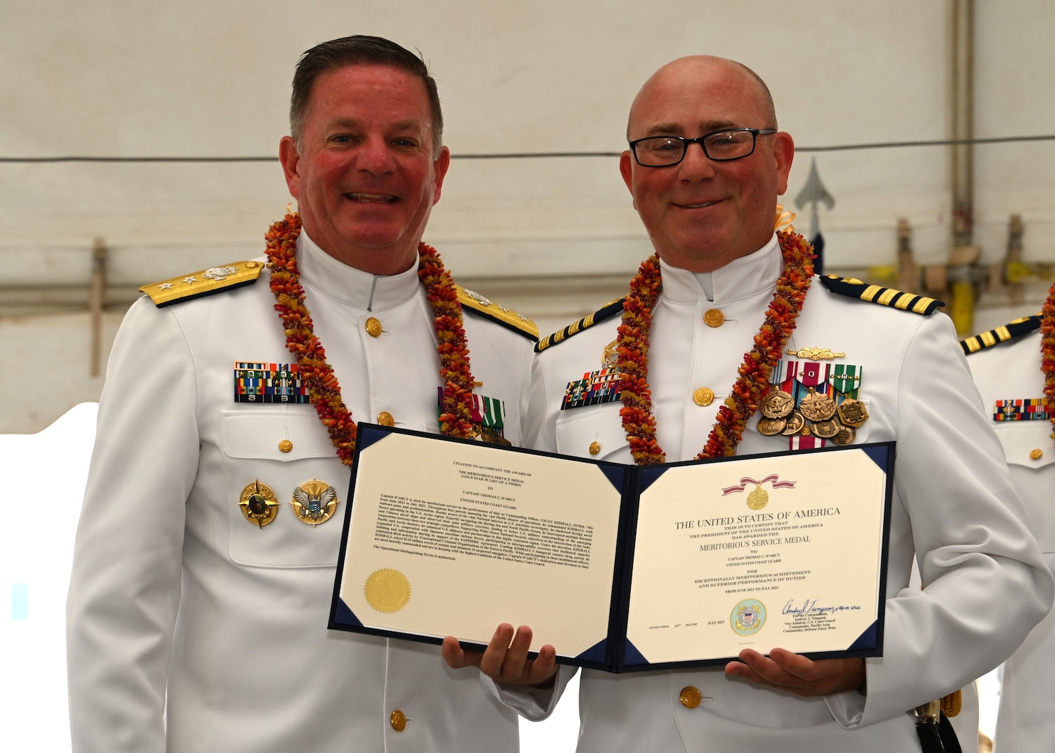 Rear Adm. Brendan C. McPherson (left), deputy commander of U.S. Coast Guard Pacific Area, presents Capt. Tom D’Arcy with a Meritorious Service Medal for his time as commanding officer of the U.S. Coast Guard Cutter Kimball (WMSL 756) during the cutter’s change of command ceremony on Base Honolulu, July 21, 2023. McPherson presided over the ceremony in which Capt. Bob Kinsey relieved D’Arcy as Kimball’s commanding officer. U.S. Coast Guard photo by Chief Petty Officer Matthew Masaschi.
