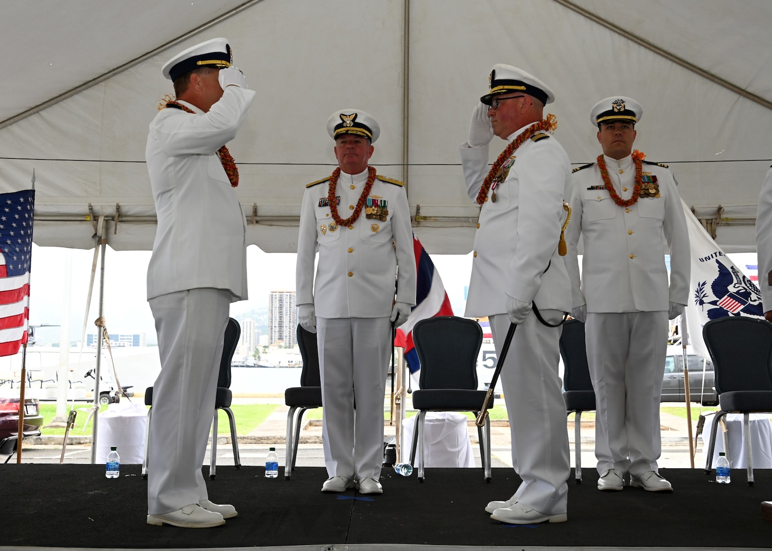 Capt. Bob Kinsey (left) and Capt. Tom D’Arcy (right) salute each other during the U.S. Coast Guard Cutter Kimball’s (WMSL 756) change of command ceremony on Base Honolulu, July 21, 2023. Rear Adm. Brendan C. McPherson (center), deputy commander of U.S. Coast Guard Pacific Area, presided over the ceremony in which Kinsey relieved D’Arcy as Kimball’s commanding officer. U.S. Coast Guard photo by Chief Petty Officer Matthew Masaschi.