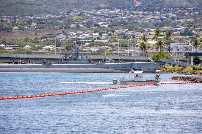 Joint Task Force-Red Hill (JTF-RH) and spill response personnel perform and observe a spill response exercise on Joint Base Pearl Harbor-Hickam, Hawaii, June 8, 2023. JTF-RH and spill response personnel use utility boats to create a barrier with a boom to provide containment in the case of a spill. A rapid response skimmer boat and a vacuum truck with an attached portable skimmer is used to vacuum any contaminants present in the contained area. This exercise is mandated by the DOH emergency state order and the EPA 2023 Consent Order. JTF-RH Response Directorate’s sole purpose is to protect the aquifer and environment by analyzing every possible spill scenario and developing appropriate mitigation measures. JTF-RH is committed to working with all local, state, and government agencies to ensure Red Hill is defueled safely, expeditiously, and in compliance with all federal, state and local laws, policies and regulations. (DoD photo by U.S. Army Spc. Matthew Mackintosh)