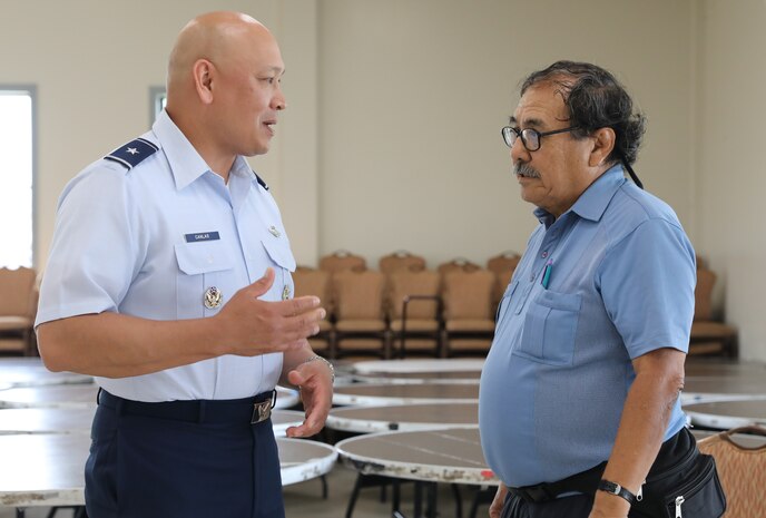 Defense Logistics Agency-Energy Commander, U.S. Air Force Brig. Gen. Jimmy Canlas, speaks with a local resident at Joint Task Force-Red Hill’s (JTF-RH) National Environmental Policy Act (NEPA) Draft Environmental Assessment/Overseas Environmental Assessment (EA/OEA) Public Meeting at Ke’ehi Lagoon Memorial, Honolulu, Hawaii, June 15, 2023. JTF-RH hosted the public meeting to provide the public with information regarding the NEPA Draft EA/OEA, accept comments, and an opportunity to engage directly with subject matter experts. JTF-RH is in phase three of its five-phase defueling plan. Personnel are focused on completing repairs, quality control tasks, training, response preparation, the NEPA Environmental Assessment, regulatory approvals and operational planning for all major milestones. This extensive preparatory work will help ensure the safe and expeditious defueling of the Red Hill Bulk Fuel Storage Facility. (DoD photo by U.S. Army Sgt. Kyler Chatman)