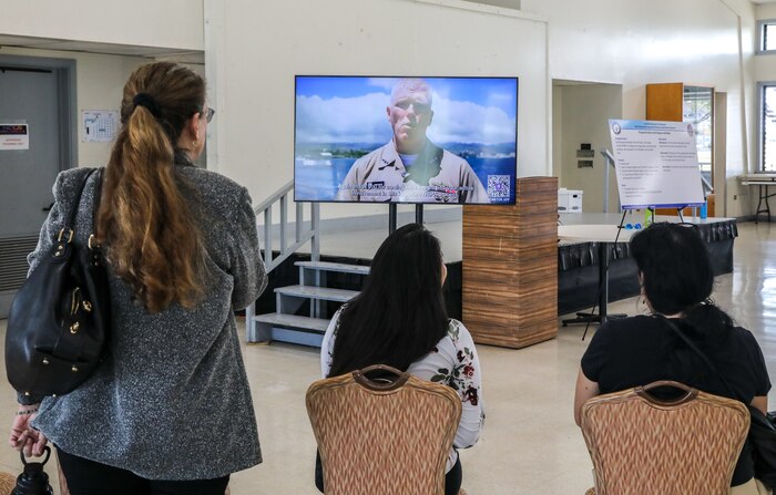 Local residents view a greeting message from Joint Task Force-Red Hill (JTF-RH) Commander, U.S. Navy Vice Adm. John Wade, during JTF-RH’s National Environmental Policy Act (NEPA) Draft Environmental Assessment/Overseas Environmental Assessment (EA/OEA) Public Meeting at Ke’ehi Lagoon Memorial, Honolulu, Hawaii, June 15, 2023. JTF-RH hosted the public meeting to provide the public with information regarding the NEPA Draft EA/OEA, accept comments, and an opportunity to engage directly with subject matter experts. JTF-RH is in phase three of its five-phase defueling plan. Personnel are focused on completing repairs, quality control tasks, training, response preparation, the NEPA Environmental Assessment, regulatory approvals and operational planning for all major milestones. This extensive preparatory work will help ensure the safe and expeditious defueling of the Red Hill Bulk Fuel Storage Facility. (DoD photo by U.S. Army Sgt. Kyler Chatman)