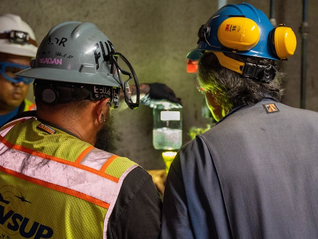 A quality assurance representative and a fuel operator with Joint Task Force-Red Hill (JTF-RH), inspect a sample of fuel during dewatering at the Red Hill Bulk Fuel Storage Facility in Halawa, Hawaii, April 19, 2023. Dewatering removes the water from the fuel storage tanks. This is a routine task for maintenance of underground fuel storage tanks and is essential to prevent corrosion and protect fuel quality. Regulators from the Hawaii Department of Health and the Environmental Protection Agency are on site during dewatering. JTF-RH is committed to working with regulators, government officials, and stakeholders to ensure Red Hill is defueled safely, expeditiously and in compliance with all applicable laws and regulations. (DoD photo by U.S. Marine Corps Sgt. Luke Cohen)