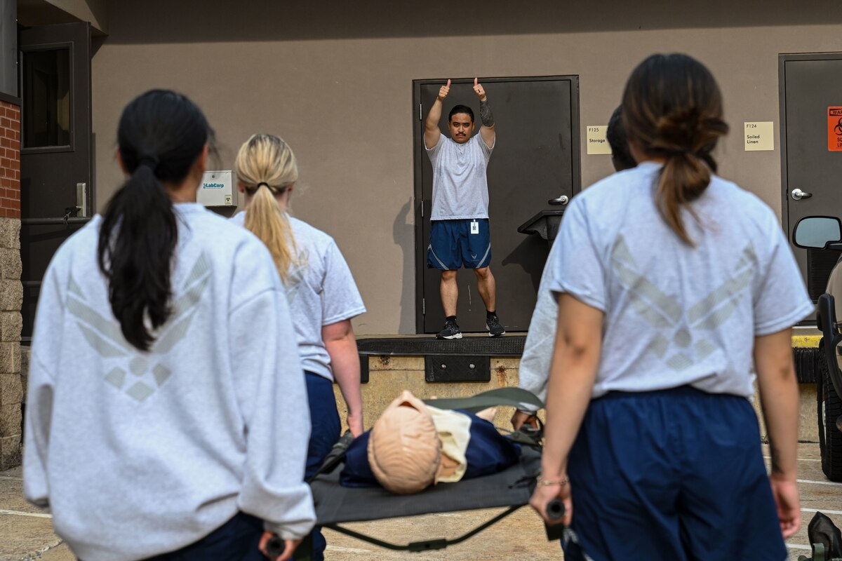 Airmen transport a simulated patient.