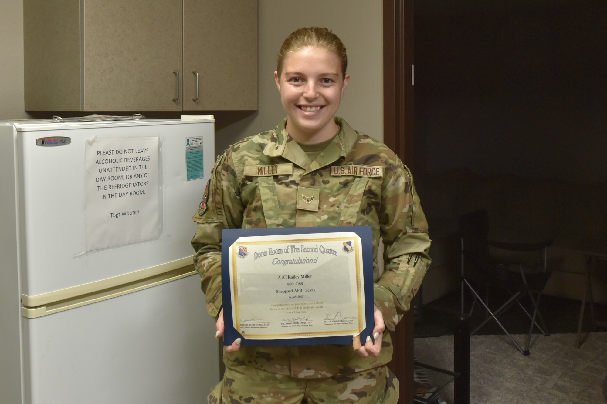 An Airman holds a certificate.