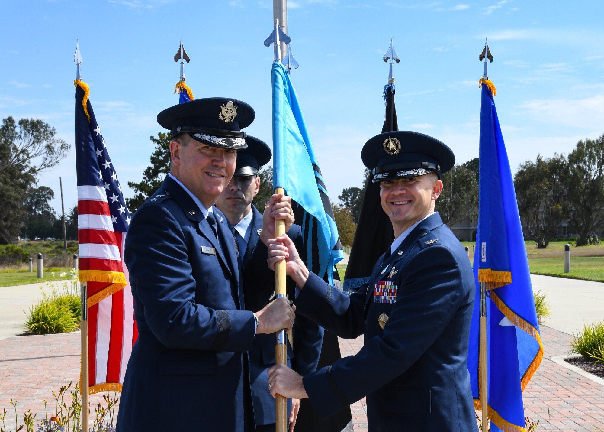 U.S. Air Force Maj. Gen. Shawn N. Bratton, Space Training and Readiness Command commander, passes the Delta 1 guidon to U.S. Space Force Col. Peter Norsky, incoming Delta 1 commander, during the Delta 1 change of command ceremony at Vandenberg Space Force Base, Calif., July 17, 2023. Norsky was the Space Force Headquarters Staff Integration Division chief prior to taking command of Delta 1. (U.S. Space Force photo by Senior Airman Rocio Romo)