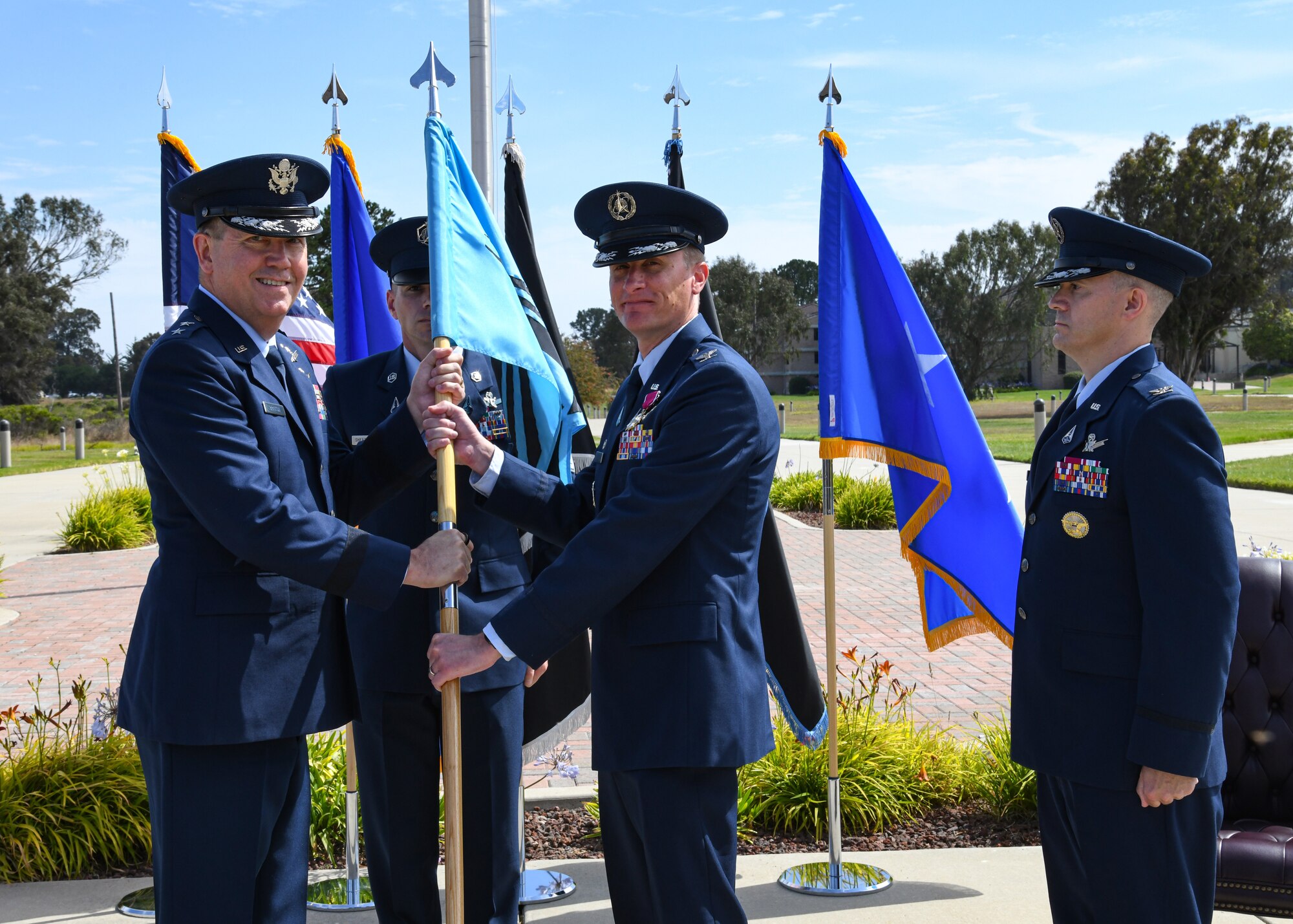 U.S. Air Force Maj. Gen. Shawn N. Bratton, Space Training and Readiness Command commander, receives the Delta 1 guidon from U.S. Space Force Col. Jason N. Schramm, outgoing Delta 1 commander, during the Delta 1 change of command ceremony at Vandenberg Space Force Base, Calif., July 17, 2023. U.S. Space Force Col. Peter Norsky, took command of Delta 1. (U.S. Space Force photo by Senior Airman Rocio Romo)