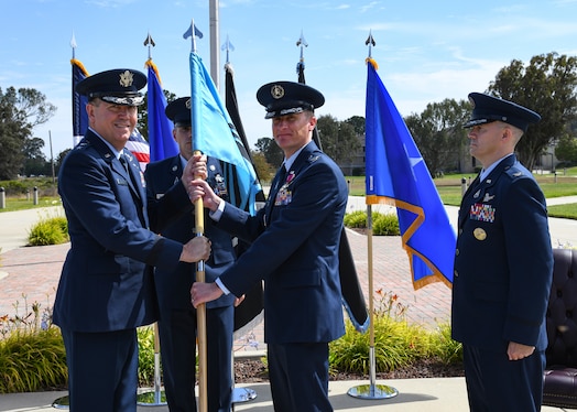  U.S. Air Force Maj. Gen. Shawn N. Bratton, Space Training and Readiness Command commander, receives the Delta 1 guidon from U.S. Space Force Col. Jason N. Schramm, outgoing Delta 1 commander, during the Delta 1 change of command ceremony at Vandenberg Space Force Base, Calif., July 17, 2023. U.S. Space Force Col. Peter Norsky, took command of Delta 1. (U.S. Space Force photo by Senior Airman Rocio Romo)
