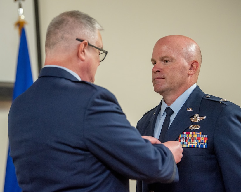 Col. David Flynn (right), outgoing director of air operations for Joint Force Headquarters—Kentucky, is pinned with the Legion of Merit by Brig. Gen. David Mounkes, Kentucky’s assistant adjutant general for Air, during Flynn’s retirement ceremony at the Kentucky Air National Guard Base in Louisville, Ky., May 20, 2023. Flynn is retiring after 28 years of military service. (U.S. Air National Guard photo by Tech. Sgt. Joshua Horton)