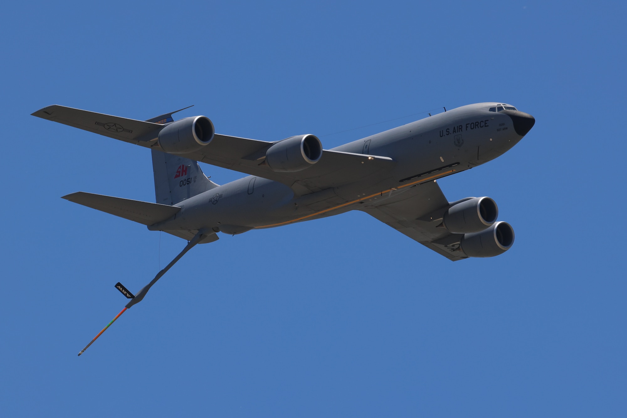 aircraft flys with refueling boom extended