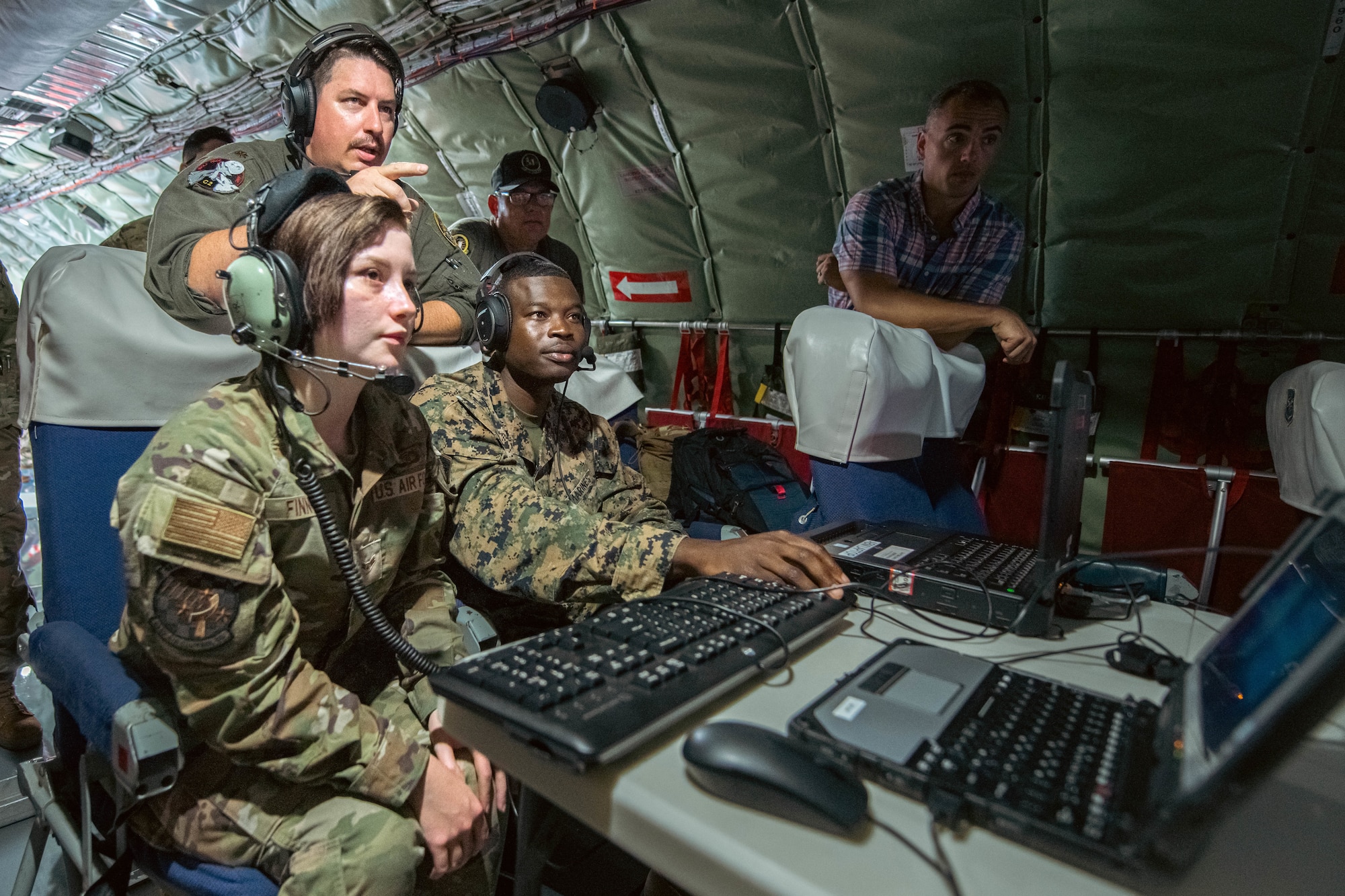 U.S. service members check satellite connections.