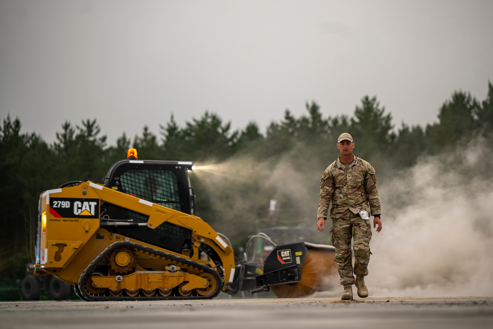 U.S. Air Force Airmen assigned to the 18th Civil Engineer Group walk across a simulated damaged runway during a bilateral live fire exercise.