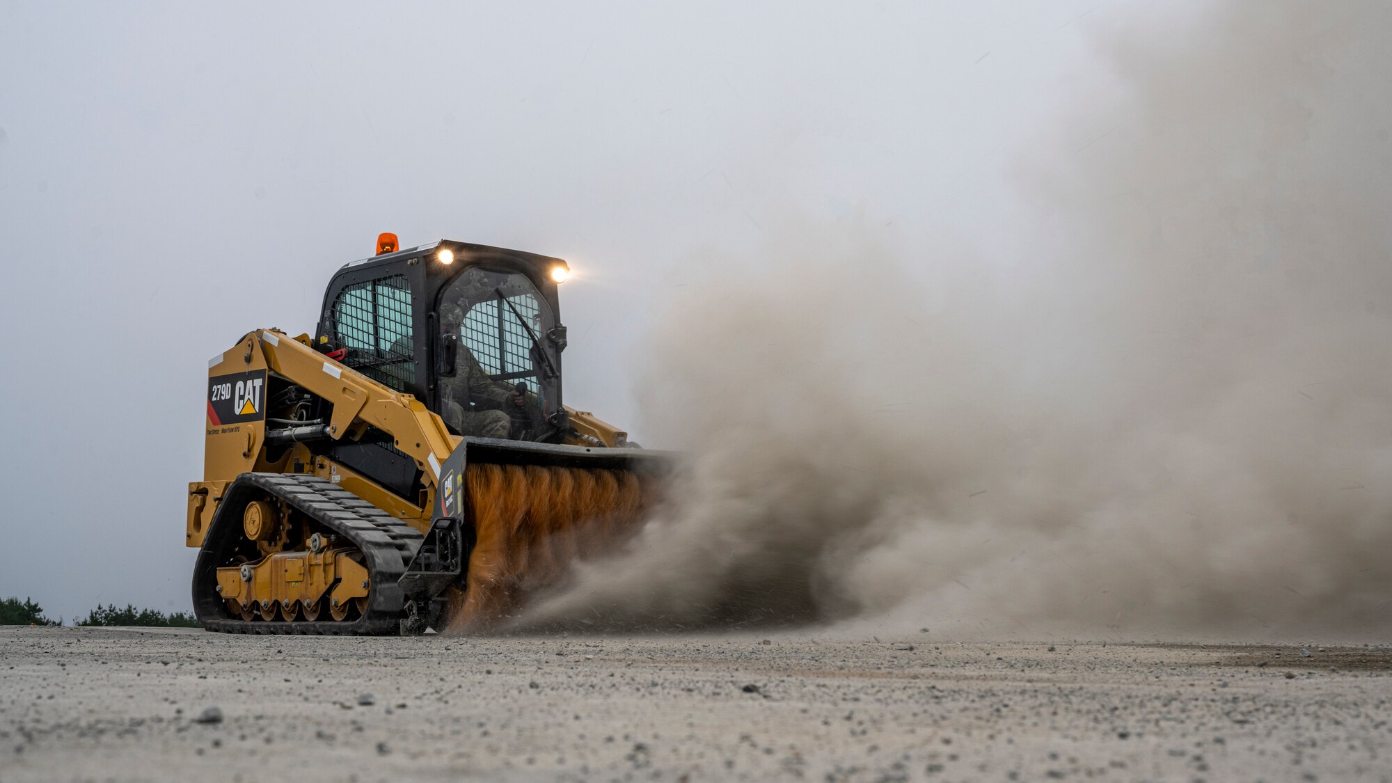 A U.S. Air Force Airman assigned to the 18th Civil Engineer Group operates a 279D Compact Truck Loader during a bilateral live fire exercise.