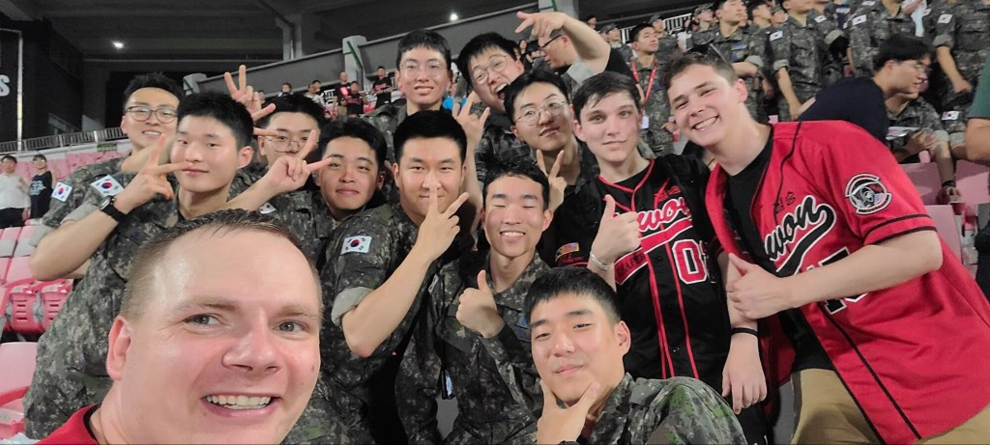 U.S. Air Force and Republic of Korea Air Force Airmen take a photo together during a baseball game at Suwon KT Wiz Park, Gyeonggi-do, ROK, June 30, 2023. The baseball game celebrated the 70th anniversary of the U.S.-ROK alliance. (U.S. Air Force courtesy photo by Maj. Joyce Lewis)