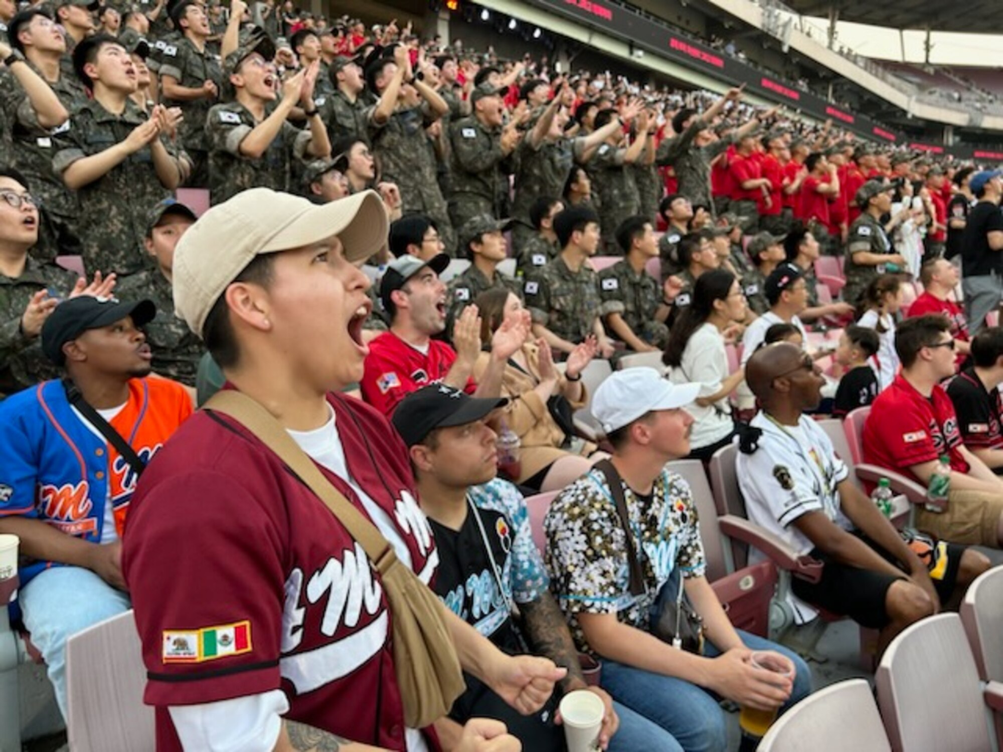 U.S. Air Force and Republic of Korea Air Force Airmen cheer for the home team during a baseball game at Suwon KT Wiz Park, Gyeonggi-do, ROK, June 30, 2023. The baseball game celebrated the 70th anniversary of the U.S.-ROK alliance. (U.S. Air Force courtesy photo by Maj. Joyce Lewis)