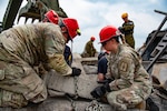 Soldiers assigned to the New York Army National Guard’s 827th Engineer Company prepare to lift a section of a simulated collapsed building during training conducted by members of the Israeli Home Front Command at the New York State Disaster Preparedness Center in Oriskany, New York, July 18, 2023, while Israeli Senior Academic Officer Raanan Ben-Sinai looks on. Fifteen Soldiers from the company, the search and extraction element of the FEMA Region II Homeland Response Force, took part in the training with members of the Fire Department New York, the New York State Office of Fire Prevention and the Missouri National Guard.