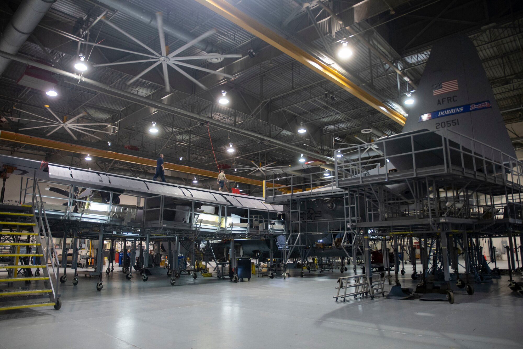 A C-130H being worked on is pictured.