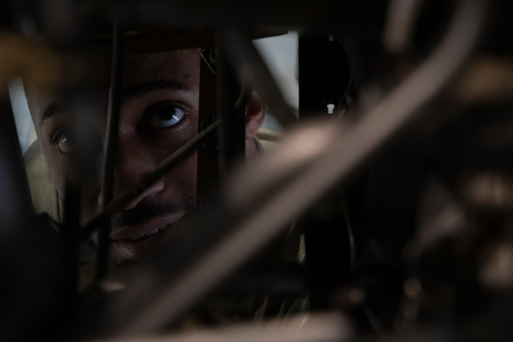 A man looks through an engine.