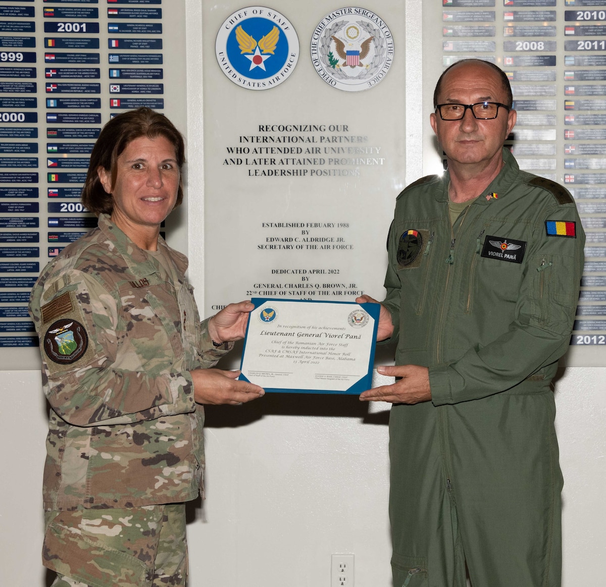 Air University Commander and President Lt. Gen. Andrea Tullos and International Officer School Commandant Col. Alexander Ganster induct Lt. Gen. Viorel Pană, Chief of the Romanian Air Force Staff, into the 2022 Chief of Staff of the Air Force and Chief Master Sergeant of the Air Force International Honor Roll at Maxwell Air Force Base, Ala., Jun. 30, 2023. International Honor Roll recognizes former Air University students who rose to the equivalent level of Chief of Staff or higher or Chief Master Sergeant of the Air Force or higher in their respective services. Pană was a 1996 graduate from AU’s Squadron Officer School. (US Air Force photo by Melanie Rodgers Cox)