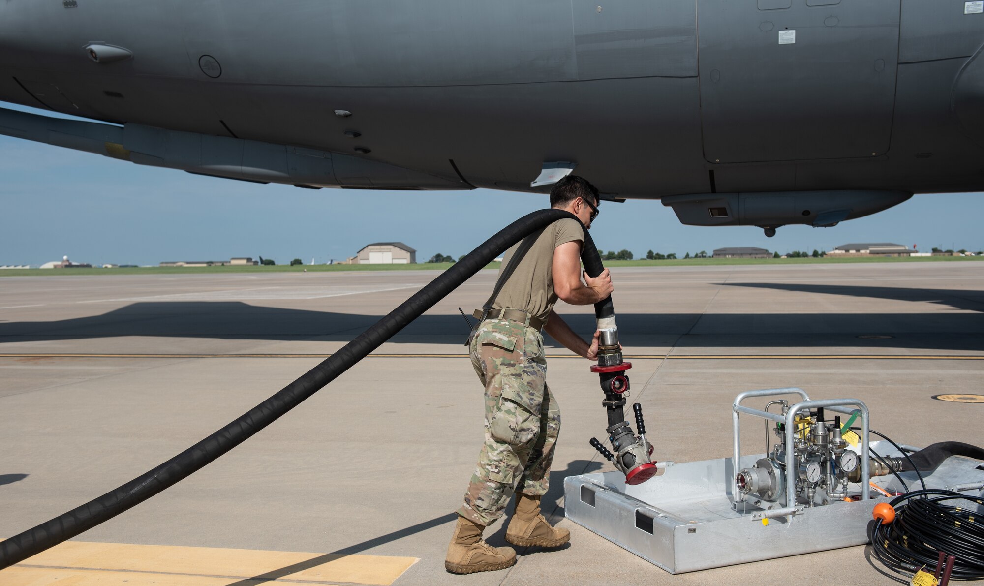 Airman 1st Class Alan Mitchell, 22nd Logistic Readiness Squadron fuels distribution operator, carries a hose from a fuel truck to a Versatile Integrating Partner Equipment Refueling (VIPER) kit July 13, 2023, at McConnell Air Force Base, Kansas. VIPER kits have the ability to conduct hot pit refueling of aircraft with any fuel infrastructure, making them a part of the Agile Combat Employment (ACE) construct. (U.S. Air Force photo by Staff Sgt. Tryphena Mayhugh)