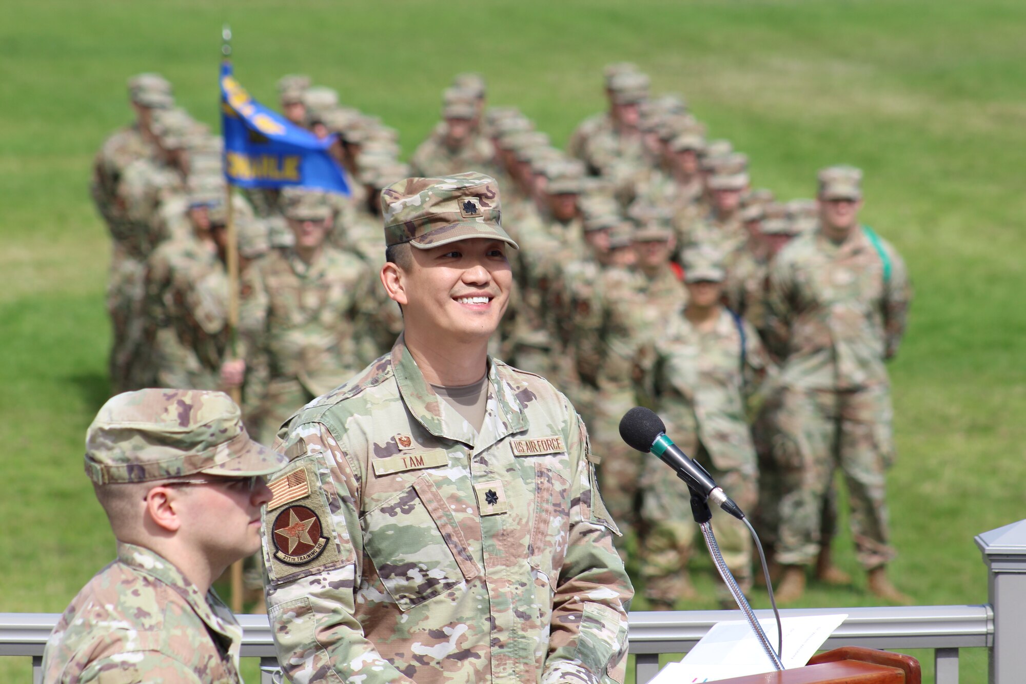 U.S. Air Force Lt. Col. Chin Tam incoming 311th Training Squadron commander, smiles during a speech upon assuming command of the 311th TRS on Soldier Field at the Presidio of Monterey, California, July 6, 2023. The change of command ceremony is a military tradition, which illustrates the formal transfer of authority by the passing of the guidon from departing commander to incoming commander. (U.S. Air Force photo by Tech. Sgt. Alexandria Holder)