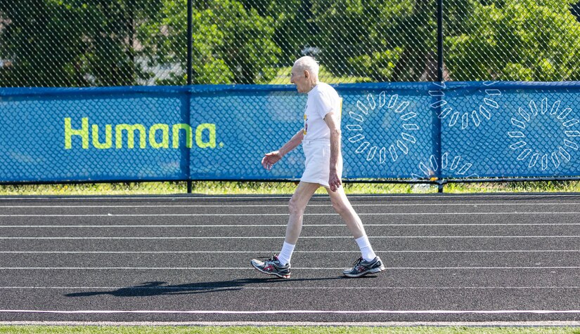 A man walks around a track.
