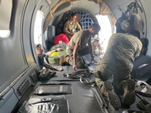 Airmen inside an aircraft reconfigure a C-146A Wolfhound.