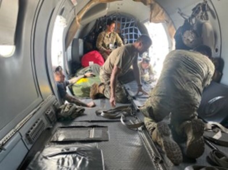 Airmen inside an aircraft reconfigure a C-146A Wolfhound.