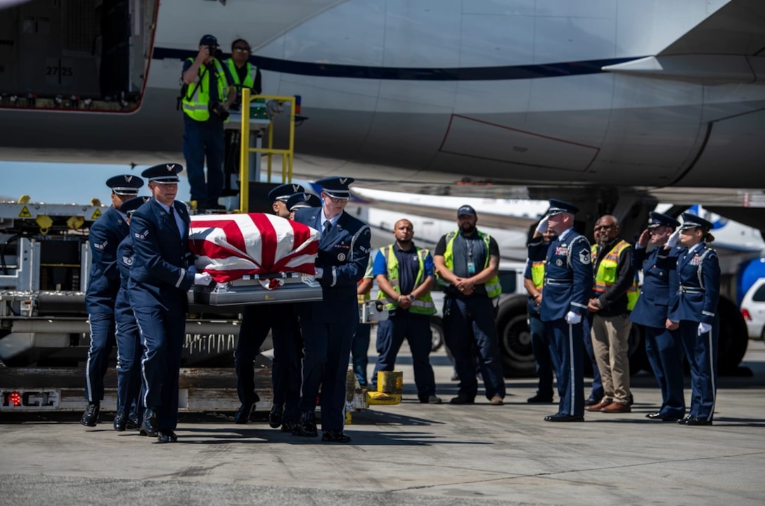 U.S. Airmen from the Travis Air Force Base Honor Guard carry the casket of Col. Ernest De Soto, during his dignified arrival at San Francisco International Airport June 29, 2023.