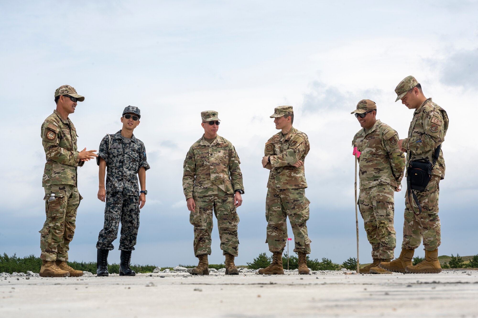 U.S. and Japan Air Self-Defense Force Airmen interact with one another during a bilateral live fire exercise.