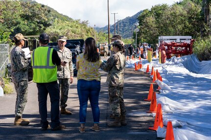 Naval Facilities Engineering Systems Command (NAVFAC) and Joint Task Force Red Hill (JTF-RH) personnel discuss safety protocols as part NAVFAC Public Works Department and JTF-RH hazard material spill recovery operation at the Red Hill Bulk Fuel Storage Facility (RHBFSF) in Halawa, Hawaii, Dec. 2, 2022. Remediation of the spill site through excavation and removal of contaminated surfaces and material was immediately initiated after an estimated 1,100 gallons of aqueous film forming foam (AFFF) concentrate spilled from the fire suppression system at RHBFSF Adit 6 on Nov. 29, 2022. JTF-RH was established by the Department of Defense to ensure the safe and expeditious defueling of the RHBFSF. (U.S. Air National Guard photo by Staff Sgt. Orlando Corpuz)