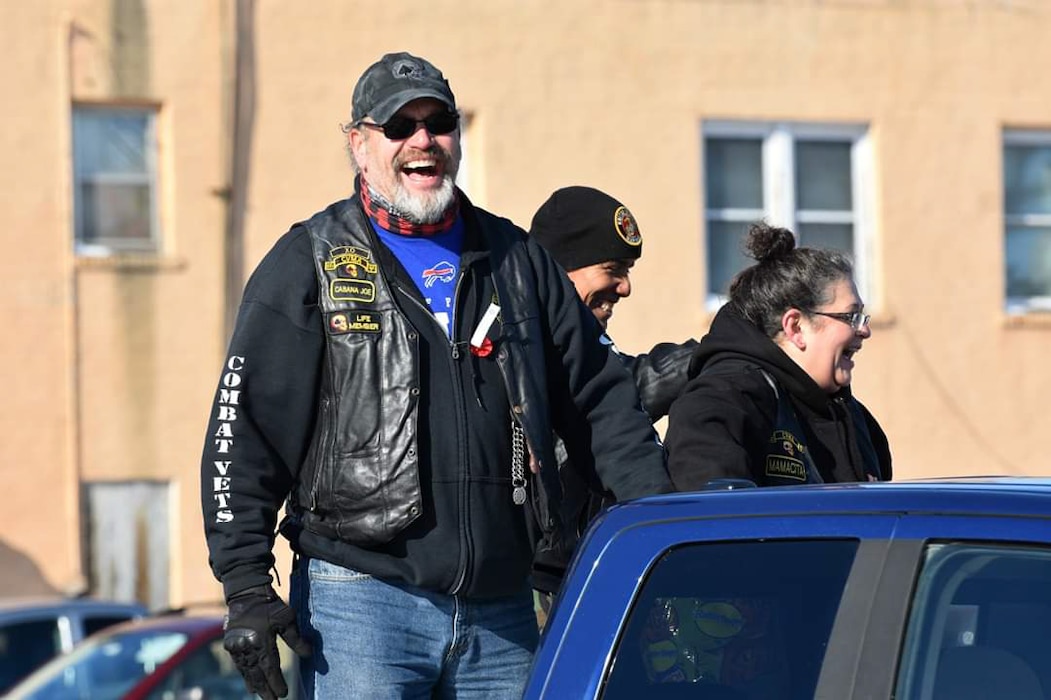 Joe Kern, 28th Civil Engineer Squadron real property specialist, and other members of the Chapter 30-1 Combat Veterans Motorcycle Association distribute candy during a parade in Rapid City, South Dakota. The association is a non-profit organization that sponsors and participates in many motorcycle-related charity events each year and donates to various local veteran care facilities and charities. (Courtesy photo)