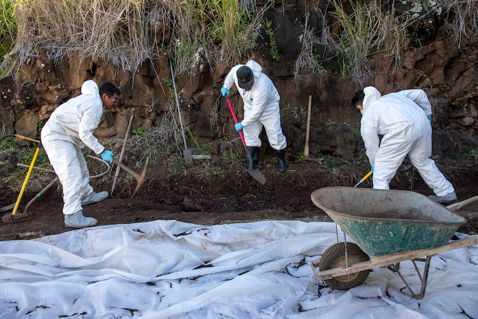 Naval Facilities Engineering Systems Command (NAVFAC) Fleet Logistics Center (FLC) Pearl Harbor employees uses tools to relocate contaminated soil onto a wheelbarrow as part of NAVFAC Public Works Department and Joint Task Force-Red Hill’s (JTF-RH) hazard material spill recovery operation at the Red Hill Bulk Fuel Storage Facility (RHBFSF) in Halawa, Hawaii, Dec. 1, 2022. Remediation of the spill site through excavation and removal of contaminated surfaces and material was immediately initiated after an estimated 1,100 gallons of aqueous film forming foam (AFFF) concentrate spilled from the fire suppression system at RHBFSF Adit 6 on Nov. 29, 2022. JTF-RH was established by the Department of Defense to ensure the safe and expeditious defueling of the RHBFSF. (DoD photo by Spc. Matthew Mackintosh)