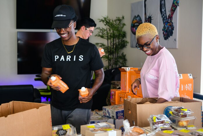 Beale Air Force Base dorm residents receive food from the food drive provided by Yuba Sutter Food Bank at the dorms on Beale Air Force Base, California, July 21, 2023.