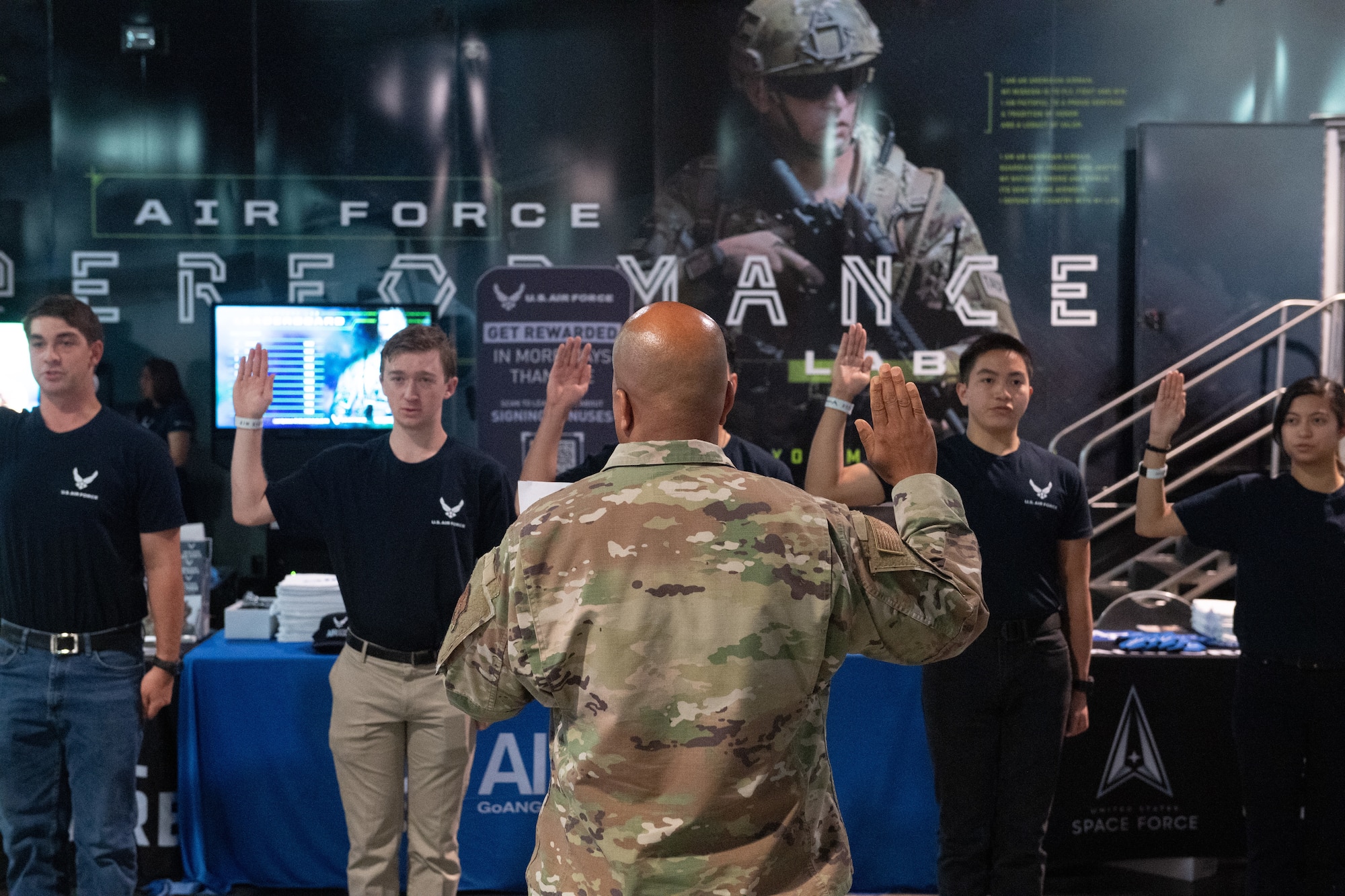 Maj. Gen. Konata Crumbly, Air National Guard advisor to the Air Force Recruiting Service commander, issues the Oath of Enlistment to five delayed enlistment program applicants at the Ultimate Fighting Championship International Fight Week event in Las Vegas, July 3-July 9, 2023.
