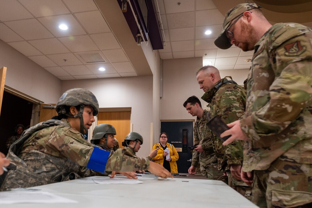 Airmen from the 8th Force Support Squadron simulate in-processing follow-on forces during training event