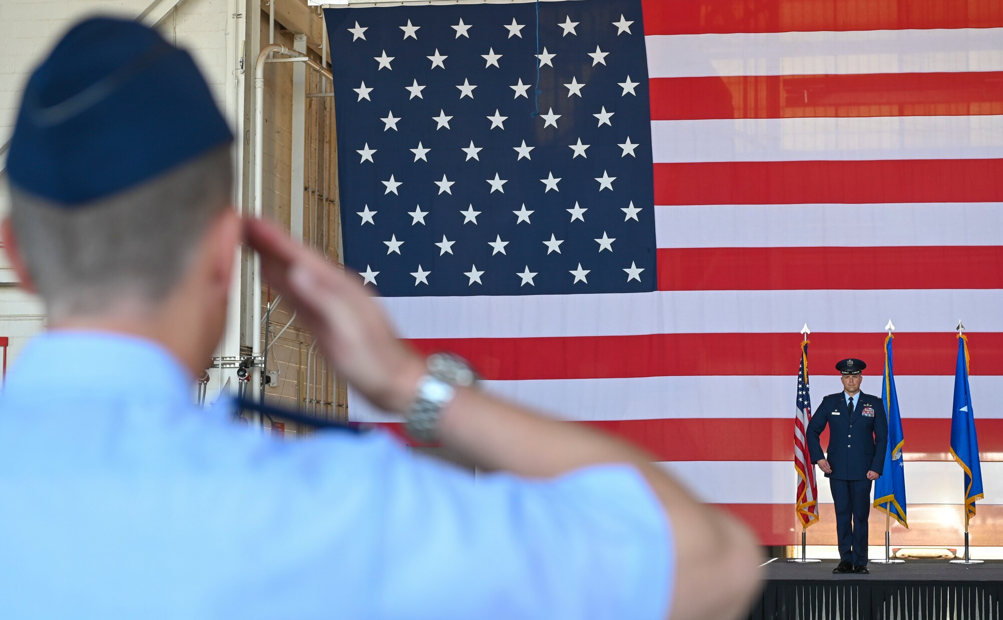 U.S. Air Force Col. Samuel Friend, 7th Bomb Wing vice commander, renders the first salute to Col. Seth Spanier, 7th BW commander, during the 7th BW change of command ceremony inside the Three Bay Hangar at Dyess Air Force Base, Texas, July 24, 2023. The ceremony symbolizes the transfer of authority between one commander to another. Spanier took command of the 7th BW from Col. Joseph Kramer. (U.S. Air Force photo by Airman 1st Class Emma Anderson)