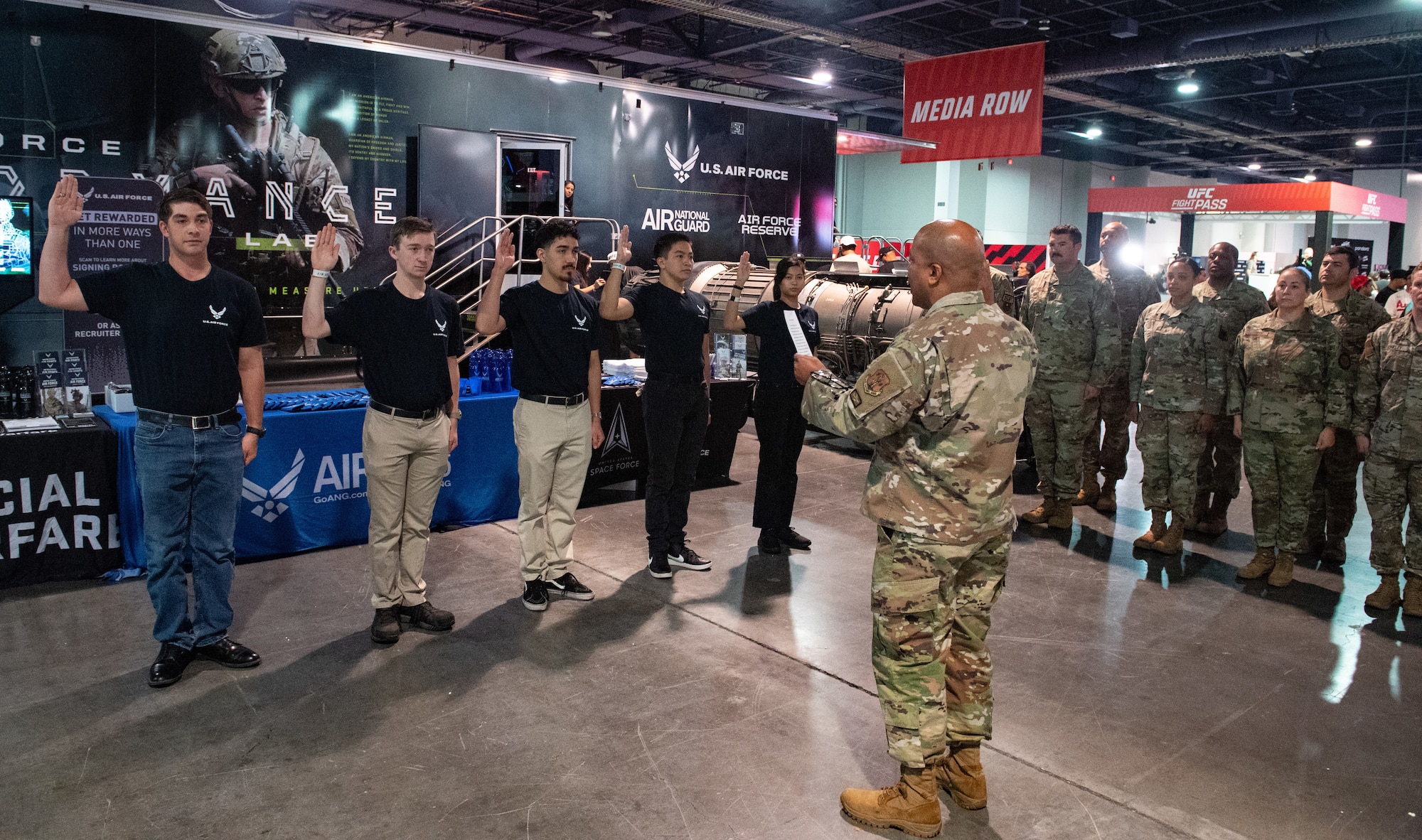 Maj. Gen. Konata Crumbly, Air National Guard advisor to the Air Force Recruiting Service commander, issues the Oath of Enlistment to five delayed enlistment program applicants at the Ultimate Fighting Championship International Fight Week event in Las Vegas, July 3-July 9, 2023.