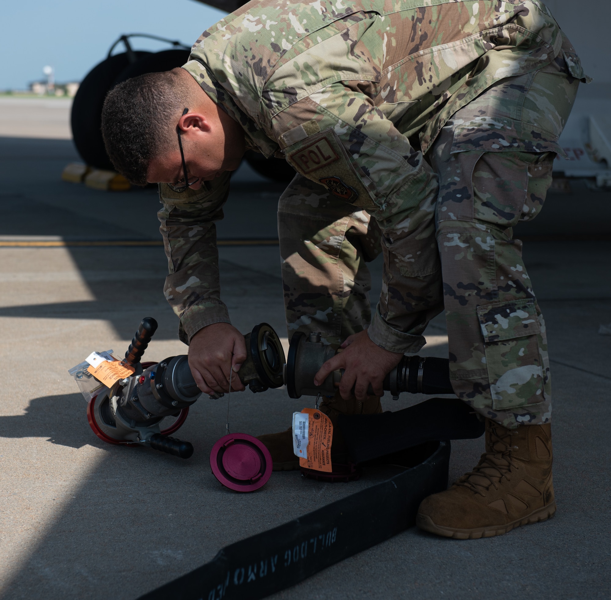 Senior Airman Felix Cruz, 22nd Logistic Readiness Squadron fuels lab technician, connects a part to a fuel hose July 13, 2023, at McConnell Air Force Base, Kansas. Cruz and other 22nd LRS Airmen hooked the truck up to a Versatile Integrating Partner Equipment Refueling (VIPER) kit, which can be used to fuel any aircraft in the world. (U.S. Air Force photo by Staff Sgt. Tryphena Mayhugh)
