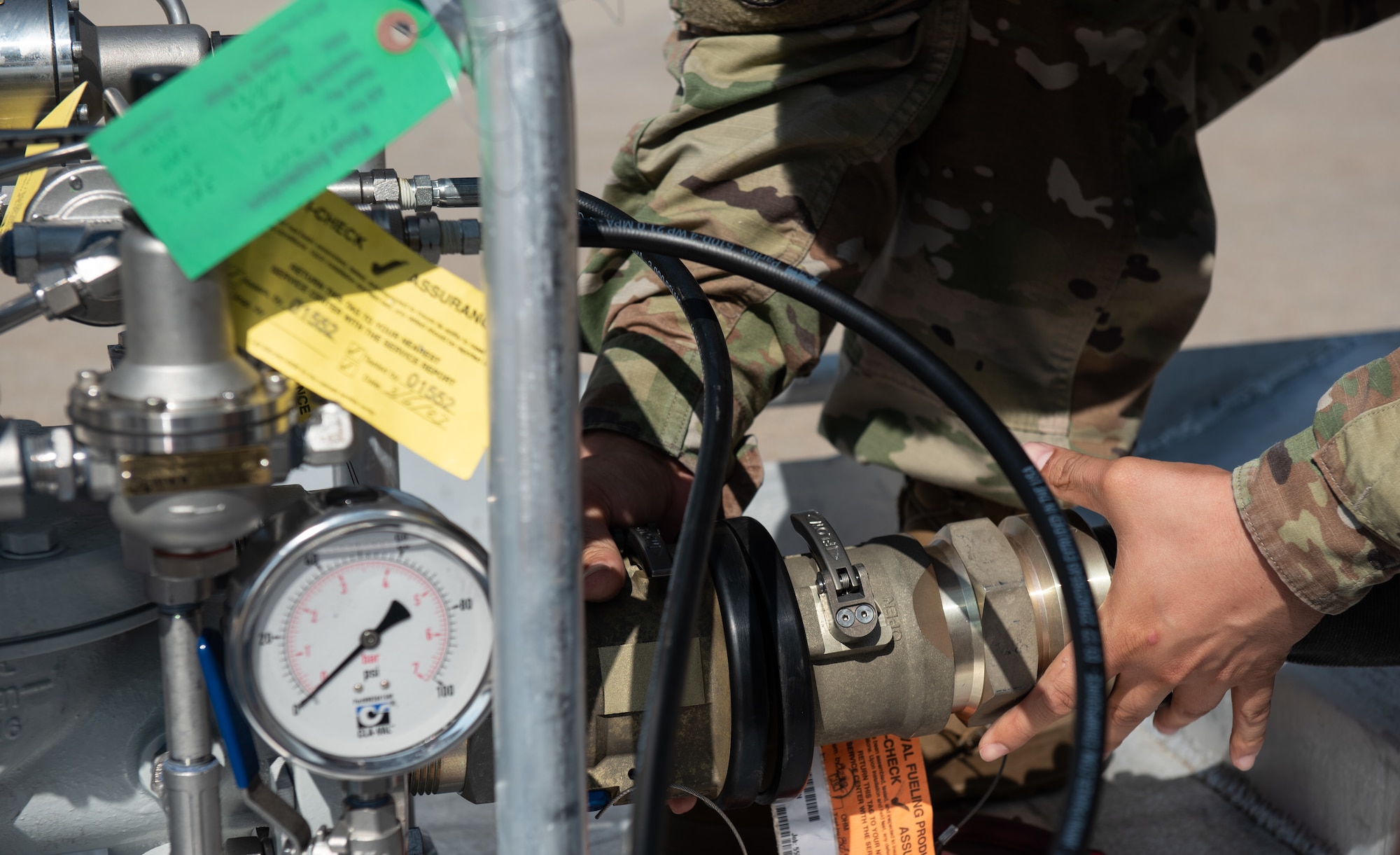 Senior Airman Felix Cruz, 22nd Logistic Readiness Squadron fuels lab technician, connects a fuel hose to a Versatile Integrating Partner Equipment Refueling (VIPER) kit July 13, 2023, at McConnell Air Force Base, Kansas. VIPER kits have the ability to conduct hot pit refueling of aircraft with any fuel infrastructure, making them a part of the Agile Combat Employment (ACE) construct. (U.S. Air Force photo by Staff Sgt. Tryphena Mayhugh)