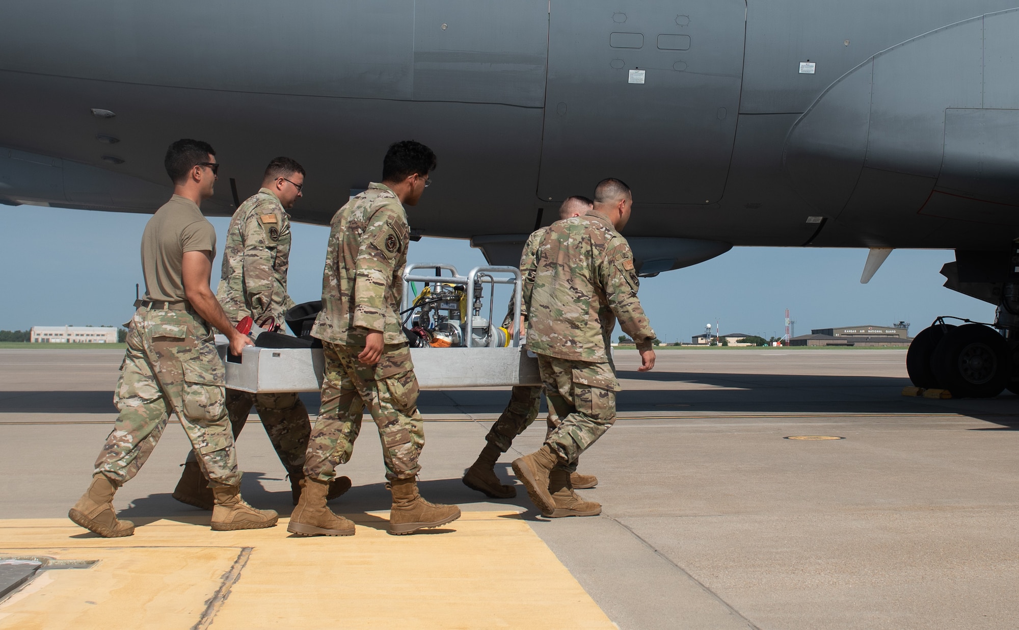 Airmen assigned to the 22nd Logistic Readiness Squadron carry a Versatile Integrating Partner Equipment Refueling (VIPER) kit to a KC-46A Pegasus July 13, 2023, at McConnell Air Force Base, Kansas. VIPER kits have the ability to conduct hot pit refueling of aircraft with any fuel infrastructure, making them a part of the Agile Combat Employment (ACE) construct. (U.S. Air Force photo by Staff Sgt. Tryphena Mayhugh)