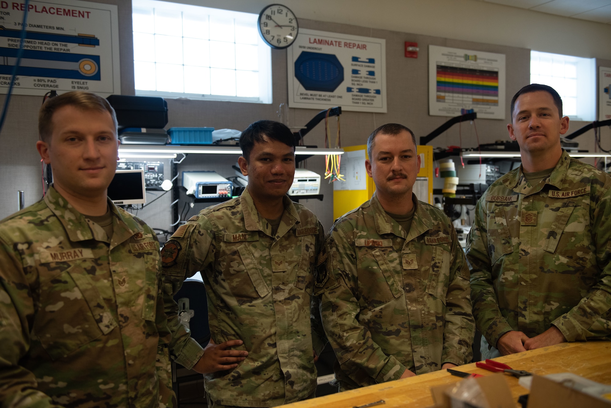 Airmen pose for a photo in their workshop.