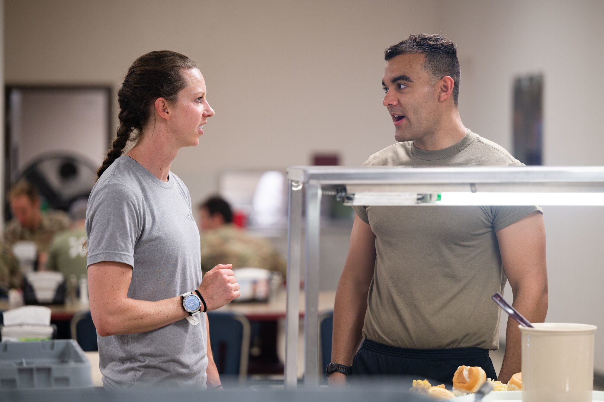 Woman speaks with trainee in the dining facility