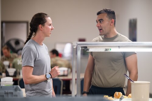 Woman speaks with trainee in the dining facility
