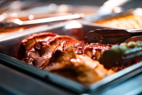 Glazed meat in a serving dish at the dining facility