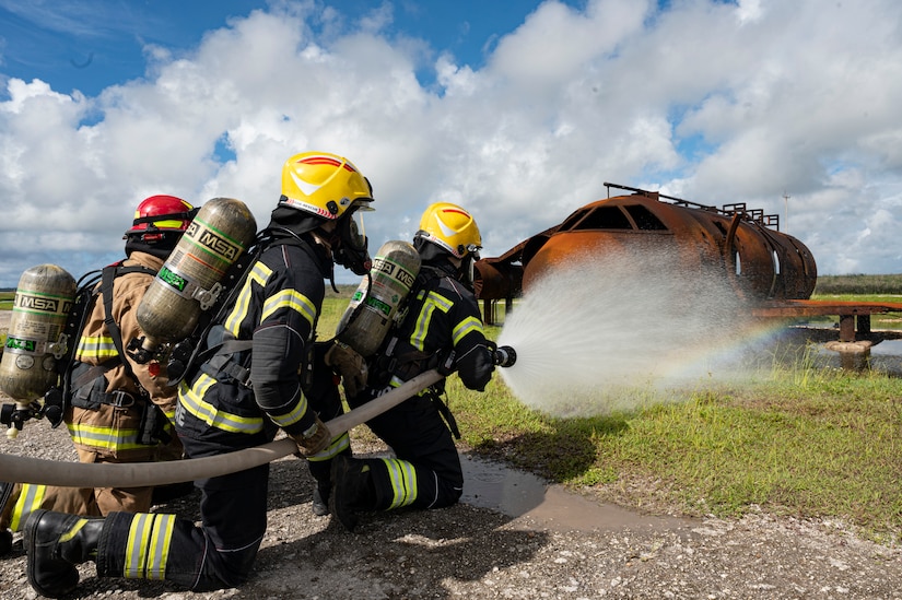 U.S. Air Force and Royal New Zealand Air Force firefighters work together during a joint live-fire training exercise during Mobility Guardian 23 at Andersen Air Force Base, Guam, July 15, 2023. MG23 saw Air Mobility Command Airmen work with joint and combined forces, including U.S. Allies and partners across the Indo-Pacific area of responsibility. (U.S. Air Force photo by Staff Sgt. Malissa Lott)
